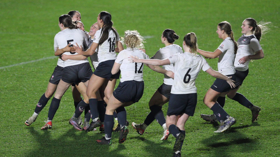 Loughborough's women's football team celebrate winning a penalty shootout